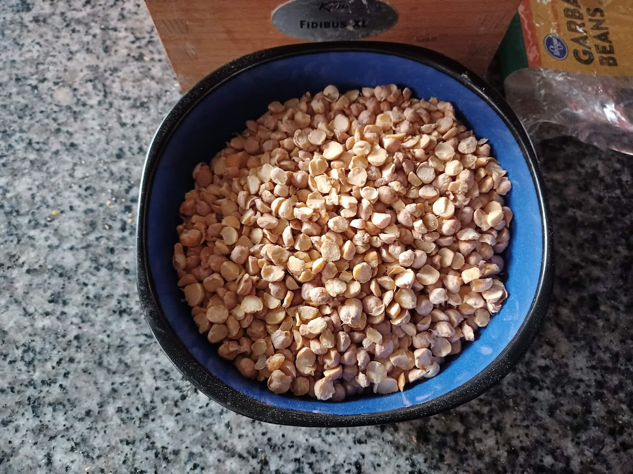Cracked garbanzo beans in a blue bowl